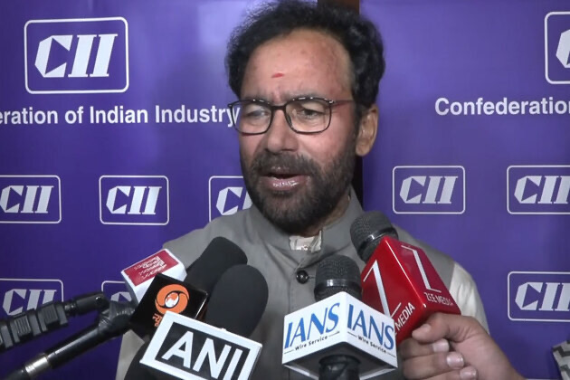 G. Kishan Reddy answering questions from reporters holding ANI, IANS and other microphones in front of a Confederation of Indian Industry backdrop